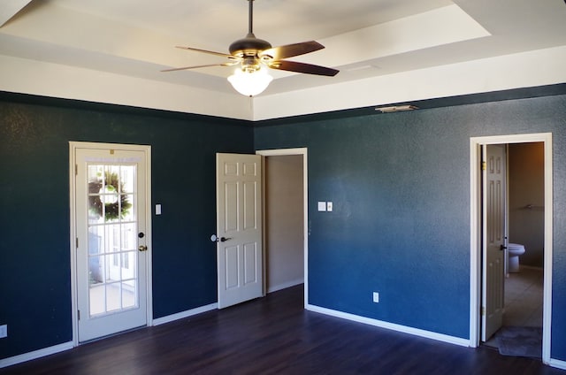 unfurnished bedroom with a ceiling fan, wood finished floors, and baseboards