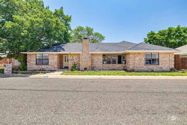 3413 Sequoia Cir, San Angelo, TX 76904 - ranch-style home with brick siding, a chimney, and roof with shingles