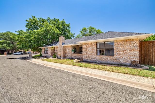 3413 Sequoia Cir, San Angelo, TX 76904 - single story home with a chimney, brick siding, and a shingled roof