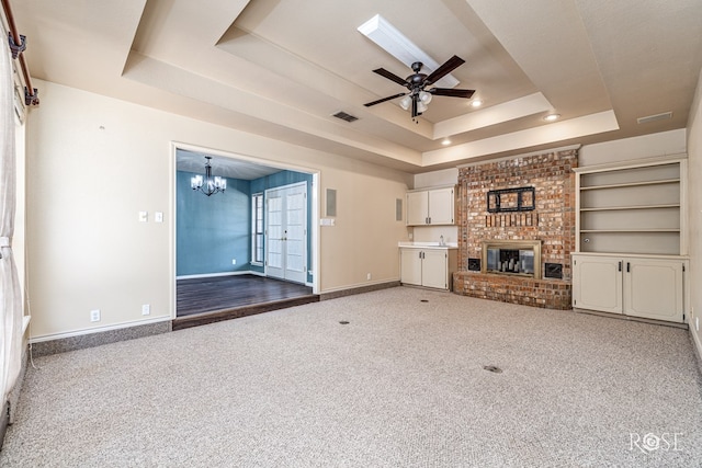 3413 Sequoia Cir, San Angelo, TX 76904 - unfurnished living room featuring a raised ceiling, a chandelier, carpet flooring, baseboards, and a ceiling fan