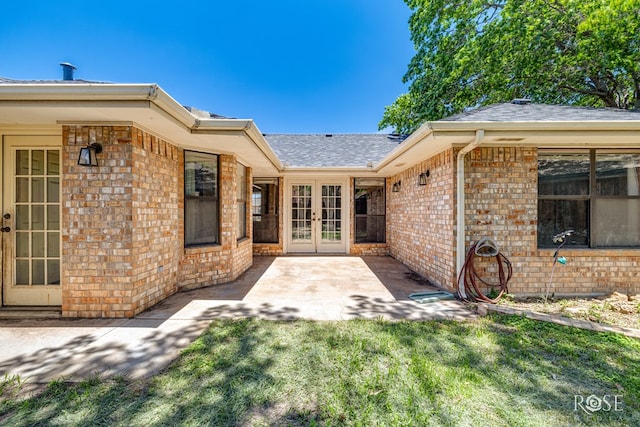 3413 Sequoia Cir, San Angelo, TX 76904 - entrance to property with french doors, roof with shingles, brick siding, and a patio area