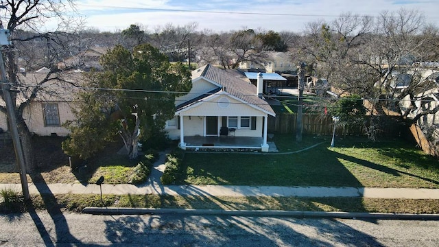 bungalow with a porch and a front lawn