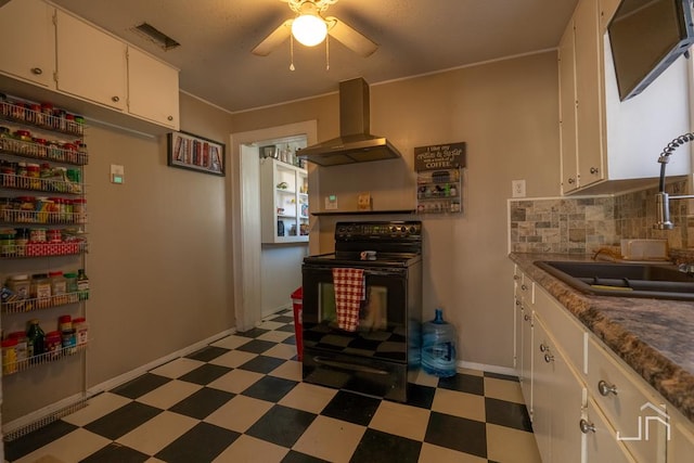 kitchen with wall chimney exhaust hood, sink, tasteful backsplash, black electric range, and white cabinets