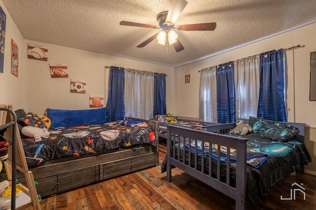 bedroom featuring hardwood / wood-style flooring, ceiling fan, and a textured ceiling