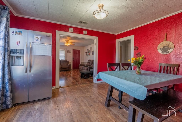 dining room featuring crown molding and wood-type flooring