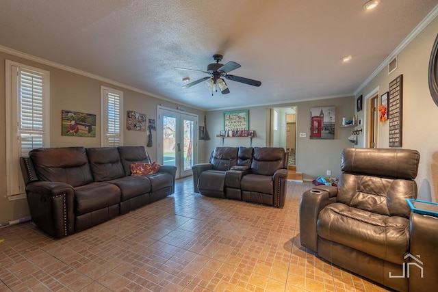 living room with ornamental molding, a textured ceiling, ceiling fan, and french doors