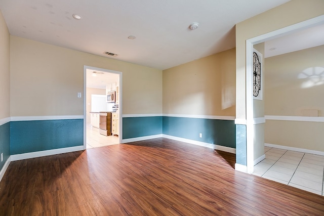 unfurnished room featuring hardwood / wood-style flooring