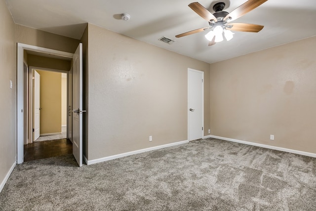 empty room featuring carpet flooring and ceiling fan