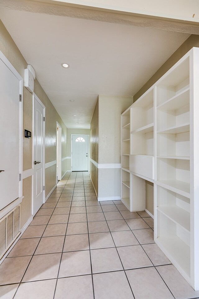 hallway featuring light tile patterned floors