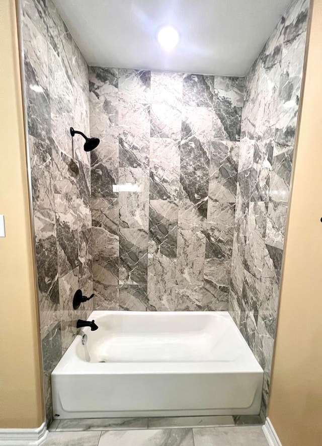 bathroom featuring baseboards and shower / bathtub combination