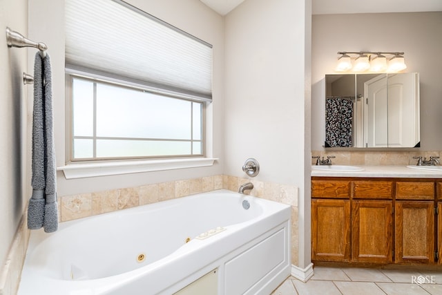 bathroom with tile patterned flooring, vanity, and a washtub