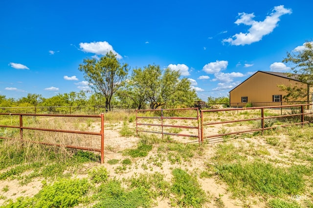 view of gate with a rural view