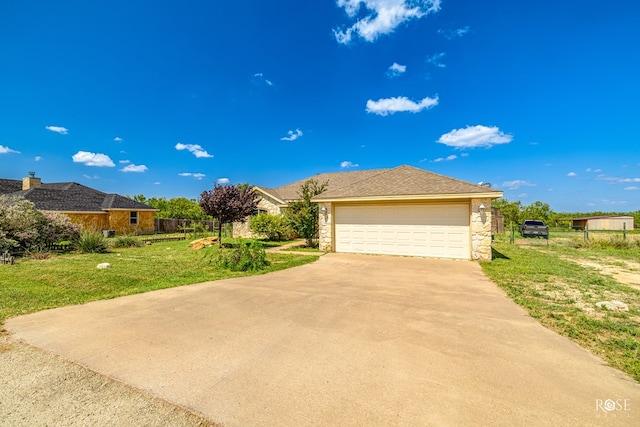 view of front of house featuring a garage and a front lawn