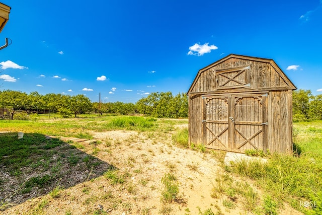 view of outdoor structure with a rural view