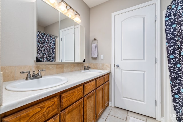 bathroom with tile patterned flooring and vanity