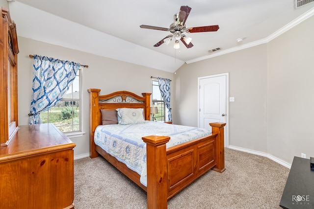 bedroom featuring ornamental molding, lofted ceiling, light carpet, and ceiling fan