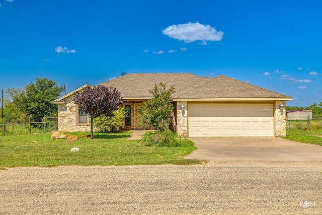 ranch-style house featuring a garage and a front yard