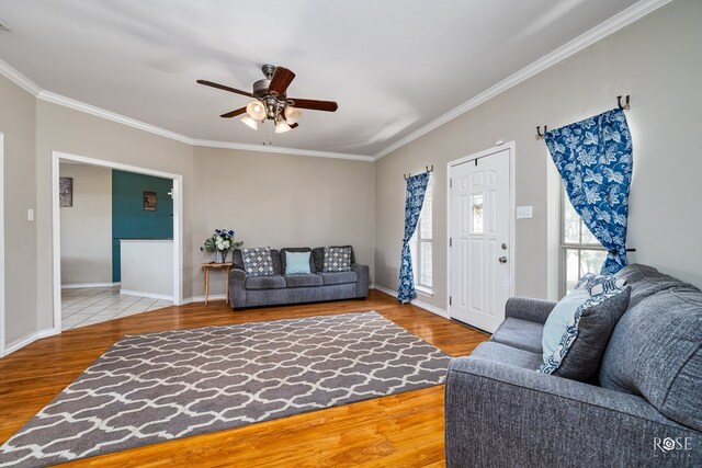 living room with crown molding, hardwood / wood-style floors, and ceiling fan