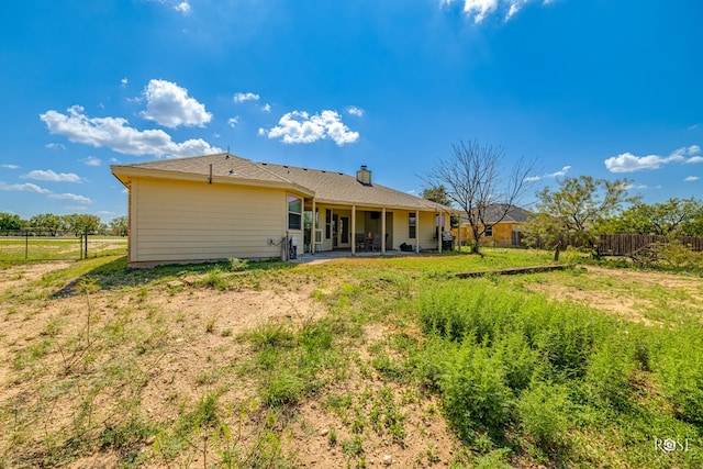 rear view of property featuring a patio area