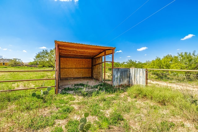 view of outdoor structure with a rural view