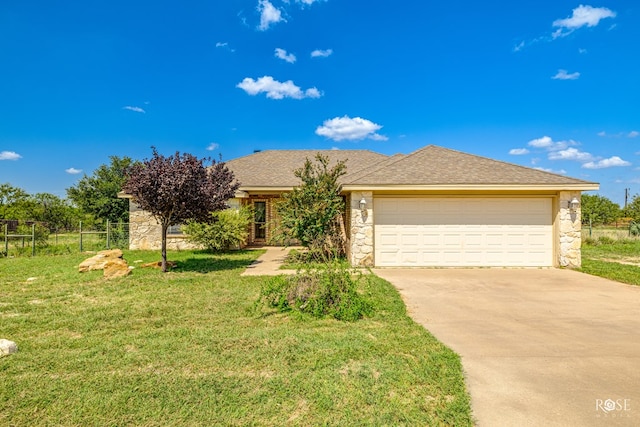 view of front of house featuring a garage and a front lawn