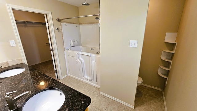 bathroom featuring vanity, tile patterned floors, and toilet