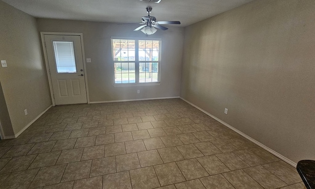 interior space with tile patterned floors and ceiling fan