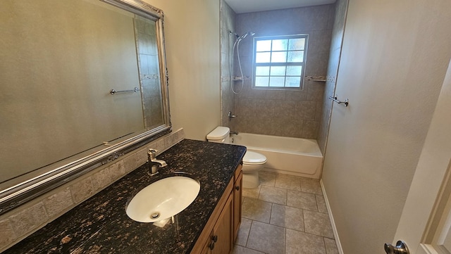 full bathroom featuring tile patterned floors, toilet, vanity, tiled shower / bath combo, and decorative backsplash