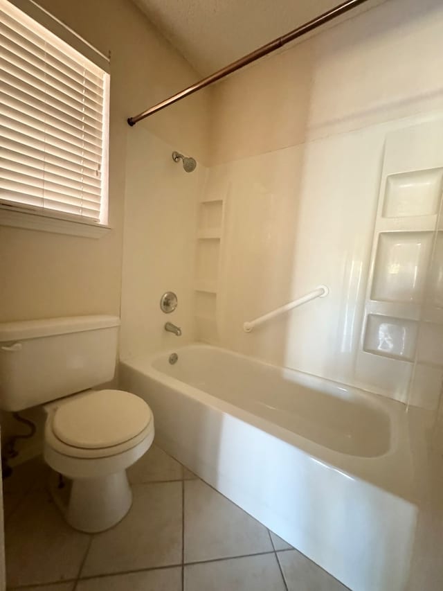 bathroom with tub / shower combination, tile patterned floors, a textured ceiling, and toilet