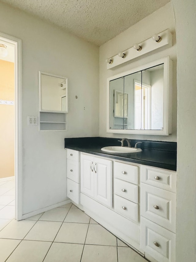 bathroom featuring tile patterned floors, a textured ceiling, and vanity