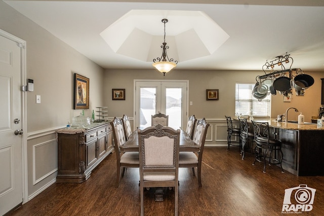 dining area featuring french doors, dark hardwood / wood-style floors, and sink