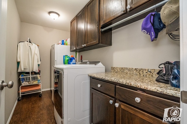 laundry area with cabinets, dark hardwood / wood-style floors, and washer and dryer