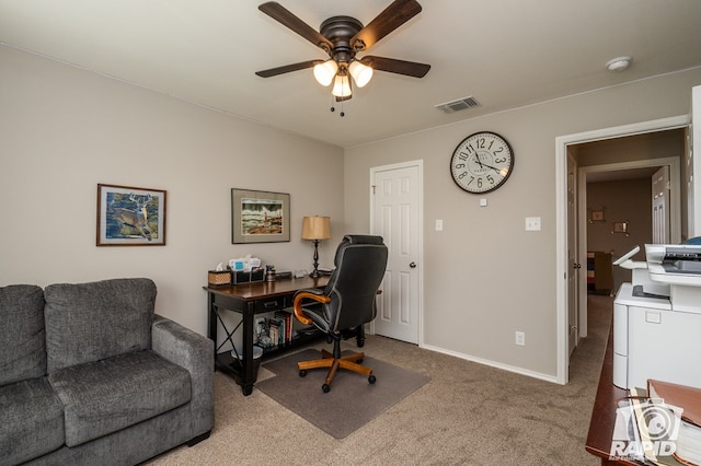 carpeted home office featuring ceiling fan