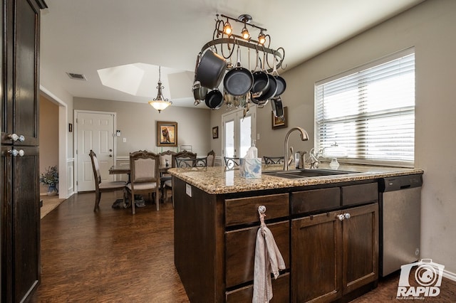 kitchen featuring dark wood-type flooring, dark brown cabinetry, sink, dishwasher, and stone counters