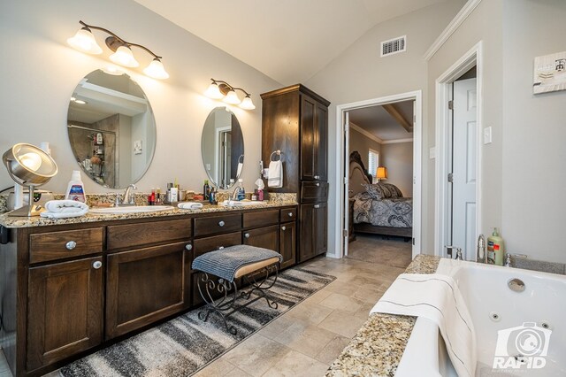 full bath with double vanity, visible vents, vaulted ceiling, a sink, and a whirlpool tub