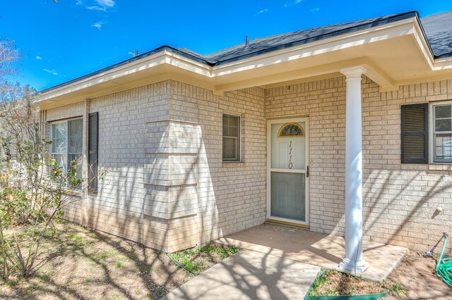 entrance to property with brick siding