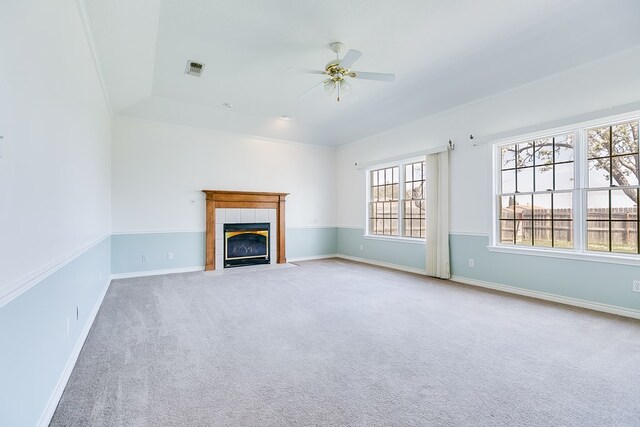 unfurnished living room with visible vents, a ceiling fan, carpet, a fireplace, and baseboards