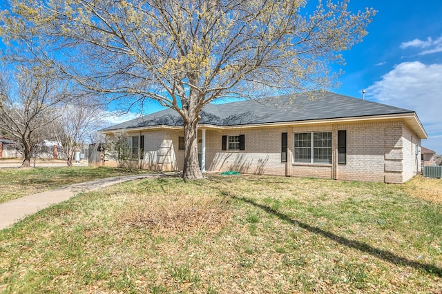 ranch-style house with brick siding and a front lawn