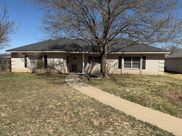 ranch-style house with brick siding, a front lawn, and fence