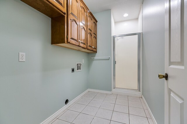 laundry area featuring cabinet space, light tile patterned floors, baseboards, hookup for an electric dryer, and hookup for a washing machine