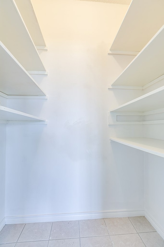 spacious closet featuring light tile patterned floors