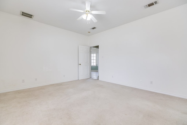 empty room featuring ceiling fan, baseboards, visible vents, and light carpet