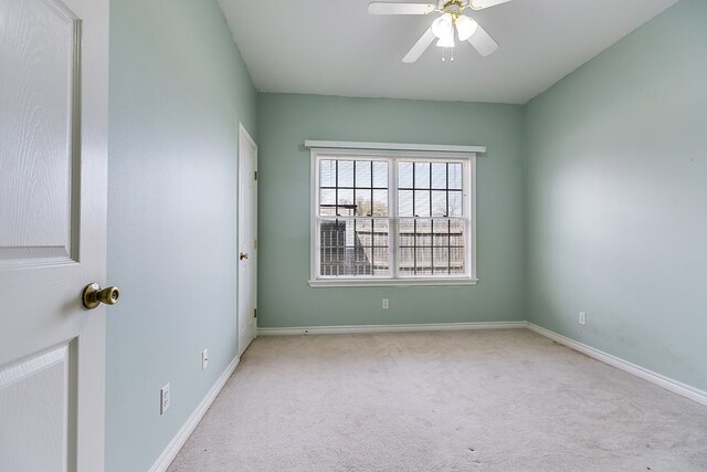 spare room featuring baseboards, carpet, and a ceiling fan