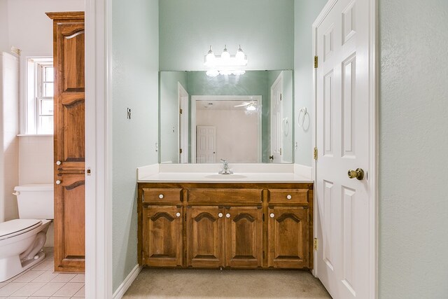 bathroom featuring vanity, tile patterned floors, and toilet