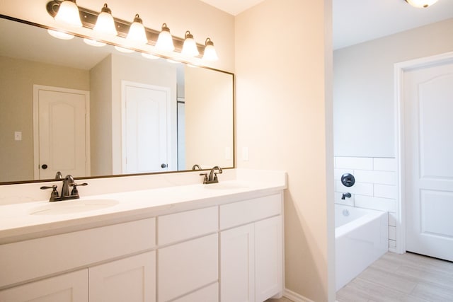 bathroom with vanity and a bath