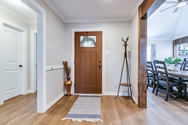 entrance foyer featuring baseboards, ceiling fan, light wood-type flooring, and crown molding