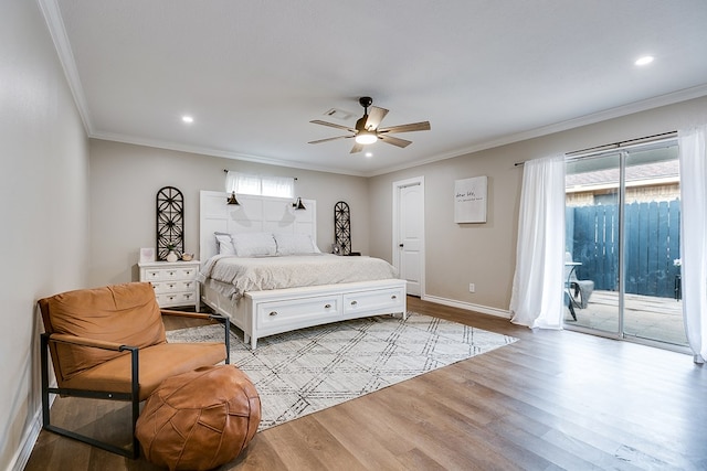 bedroom with access to outside, multiple windows, wood finished floors, and crown molding