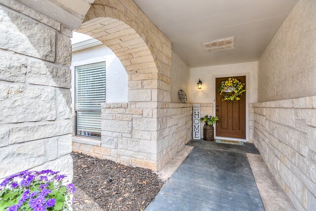 property entrance featuring stone siding