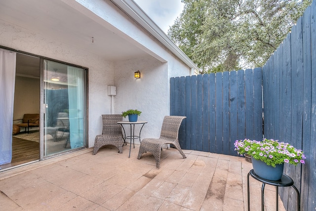 view of patio featuring fence