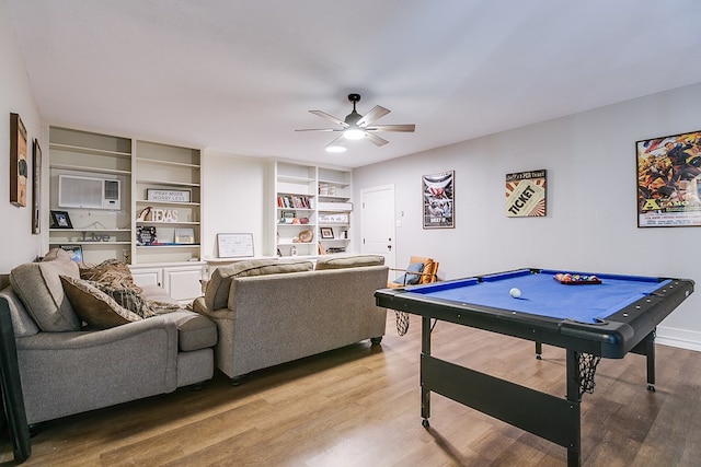 playroom with an AC wall unit, light wood-type flooring, billiards, and a ceiling fan